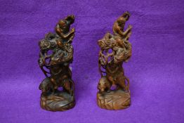 A pair of Chinese carved boxwood Luohan dragon and tiger groups, carved in relief with fine details,