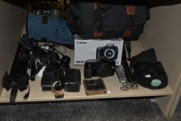 A group of cameras and tri-pod stands, to include a Instamatic camera with black leather case, a
