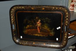 A large mid-century metal serving tray, hand-painted depicting a female figure within a floral