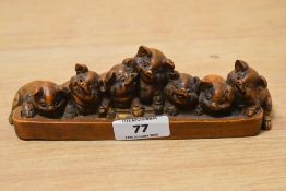 A 20th century Chinese carved boxwood group, depicting seven smiling piglets huddled around a