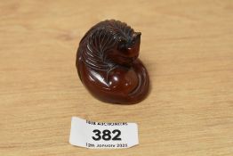 A 19th century Japanese carved amber netsuke cat, signed to base, h3.5cm