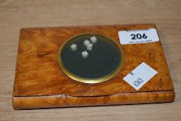 An early 20th century Burr wood case with miniature dice under glass.