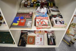Two shelves of 1970's and later Manchester United Memorabilia including a large collection of