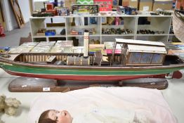 A wooden model boat named Queen Victoria, ex liver steam but all motors have been removed, on wooden