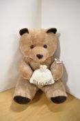A modern Teddy Bear seated holding a Sugar Bag, height 45cm