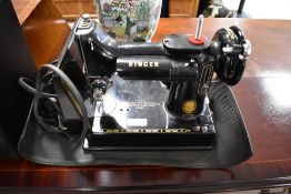 A vintage Singer 221K sewing machine, in case