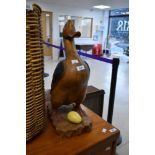 A wooden ornament modelled as duck or goose with egg, height approx. 51cm