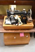 A vintage electric sewing machine in domed ply case, serial number Y6352780