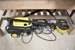 A Karcher pressure washer and attachments