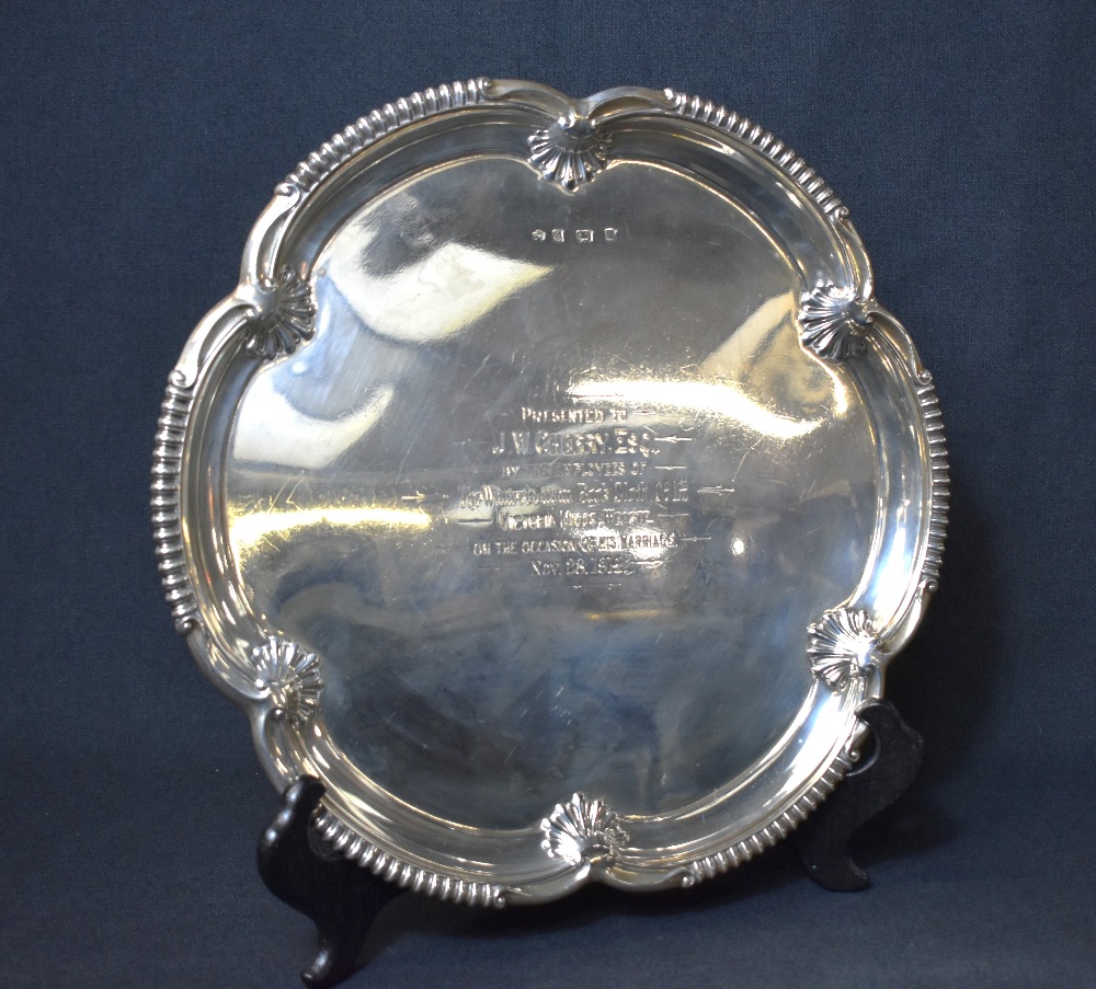 A late Edwardian silver salver, having a lobed rim with gadrooned sections and shell decoration,