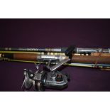 Four fibreglass spinnning rods one with a Daiwa A-400RL reel attached