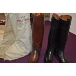 2 sets of riding boots one simulated leather and a set of brown leather boots in a harry hall boot