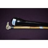 An ebonised police or knocking stick 91cm long and a small cane stick 77cm long with carved horn