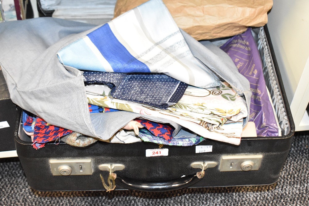 A vintage faux leather suitcase containing various fabric, mainly off cuts, to include cotton,