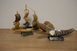 A carved bull horn fish study, L23cm, sold alongside a hand carved ship, H19cm.