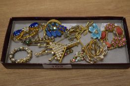 A small selection of brooches and stick pins, including enamelled pieces, paste set examples and a