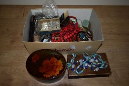 A large assortment of costume jewellery, including beaded jewellery, wristwatches, filigree