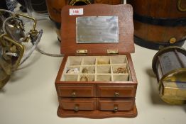 A wooden jewellery box, containing a small assortment of costume jewellery, including hoop earrings,