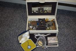 A cream embroidered jewellery box, containing a collection of costume jewellery including