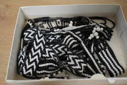 A collection of four African beaded necklaces, two having porcupine quills beads.