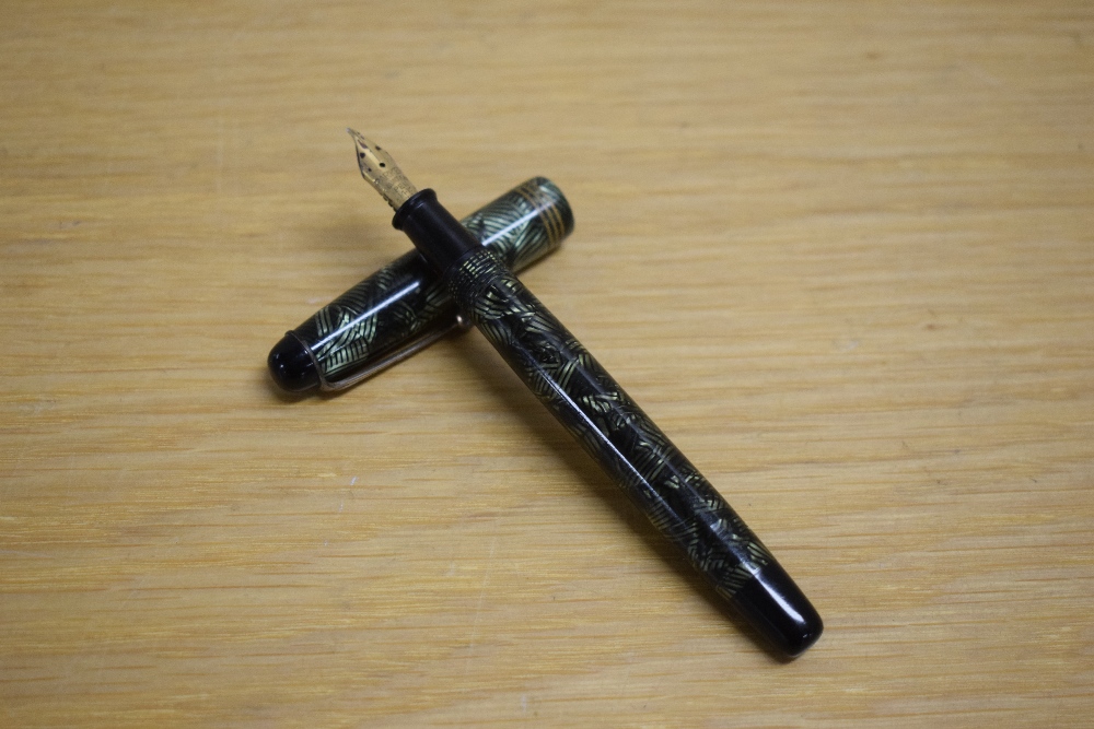 A Parker Televisor Slender button fill fountain pen in lined green with three gold cap bands