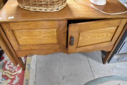 A late 19th or early 20th Century golden oak side cabinet (some signs of historical worm to back)