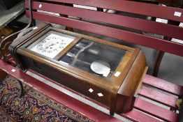 An early 20th Century oak cased wall clock having silvered dial