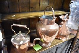 A vintage copper gallon measure, copper kettle and double spouted pot