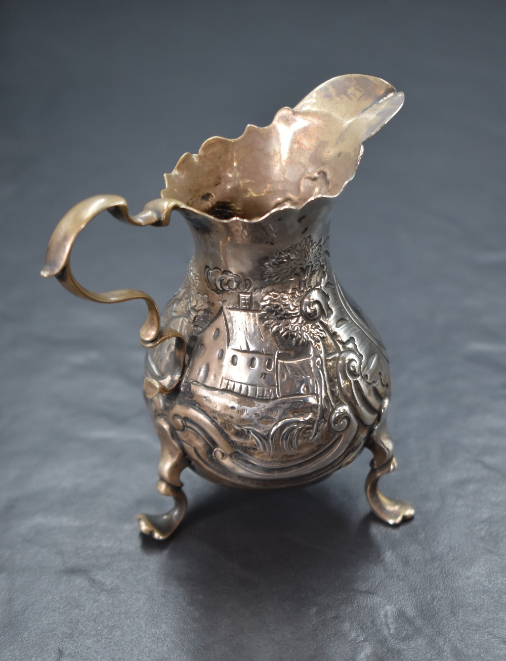 A Georgian silver cream jug, of bulbous form having a Chippendale style rim, shallow spout opposed - Image 2 of 5