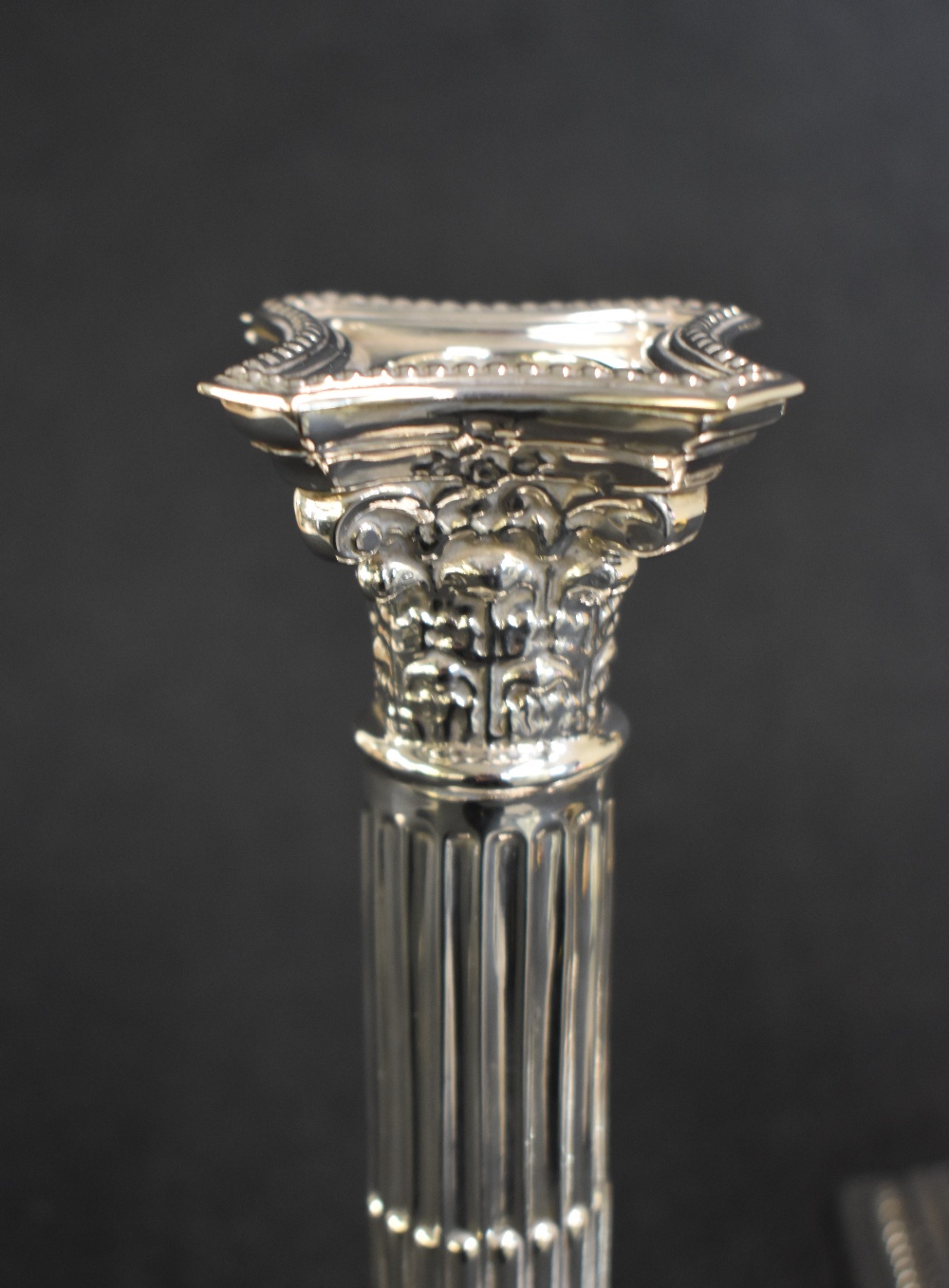 A pair of George V silver Corinthian column candlesticks, having concave square detachable sconces - Image 3 of 4