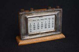 A George V silver mounted perpetual desk calendar, of rectangular form having bead thread