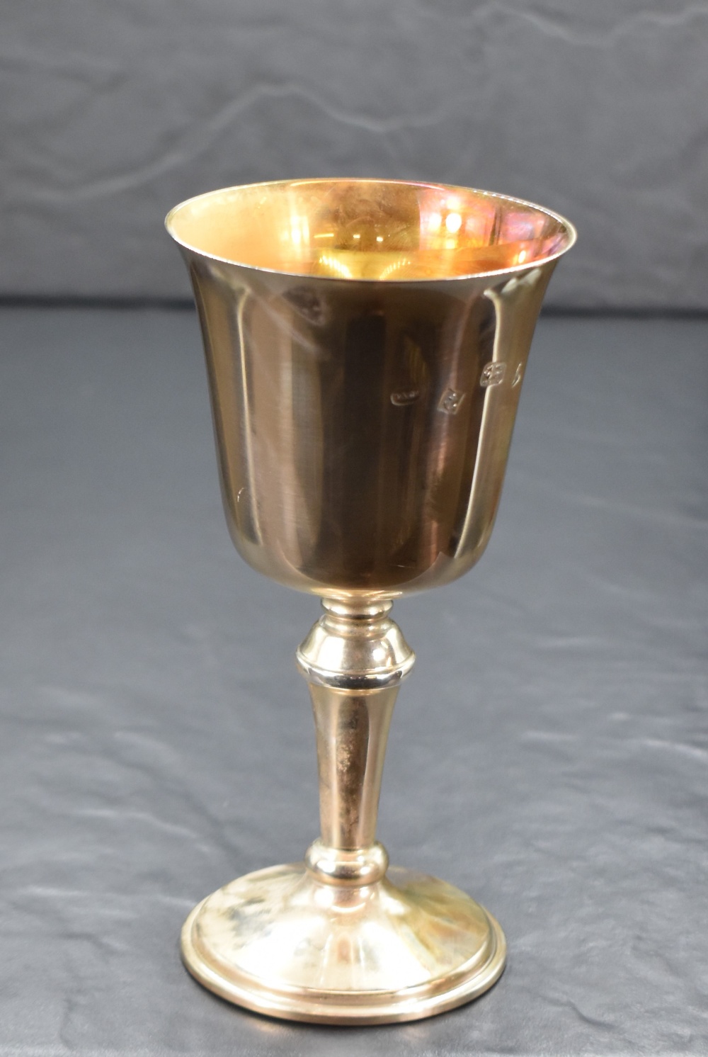 A cased Elizabeth II silver cup, of traditional form having a slightly flared rim, gilted interior