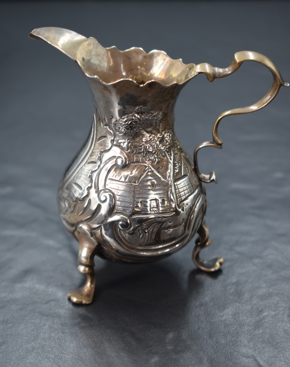 A Georgian silver cream jug, of bulbous form having a Chippendale style rim, shallow spout opposed - Image 3 of 5