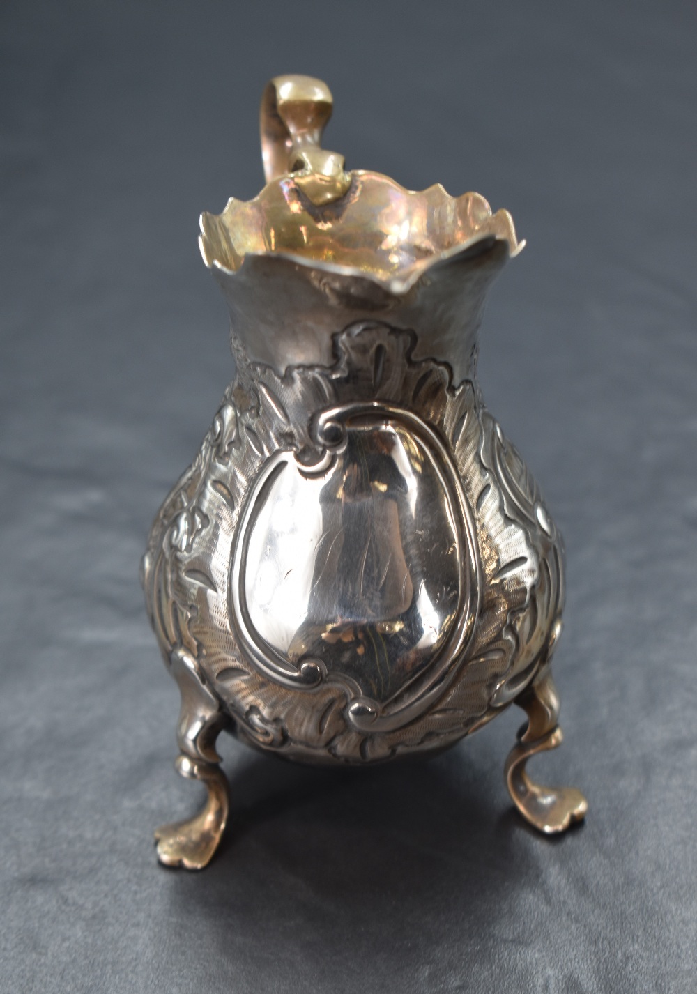 A Georgian silver cream jug, of bulbous form having a Chippendale style rim, shallow spout opposed - Image 4 of 5