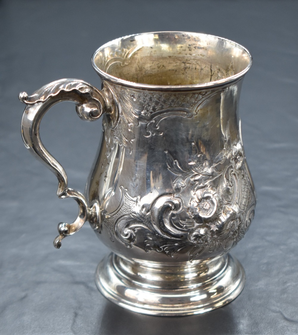 A Victorian silver tankard, of traditional bulbous form having a slightly flared rim, scroll handle,