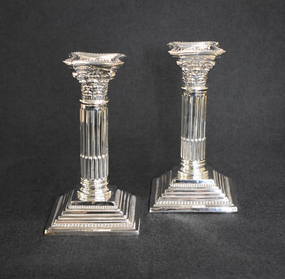 A pair of George V silver Corinthian column candlesticks, having concave square detachable sconces - Image 2 of 4