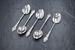 A group of five late Edwardian silver teaspoons, having twisted handles with decorative embossed