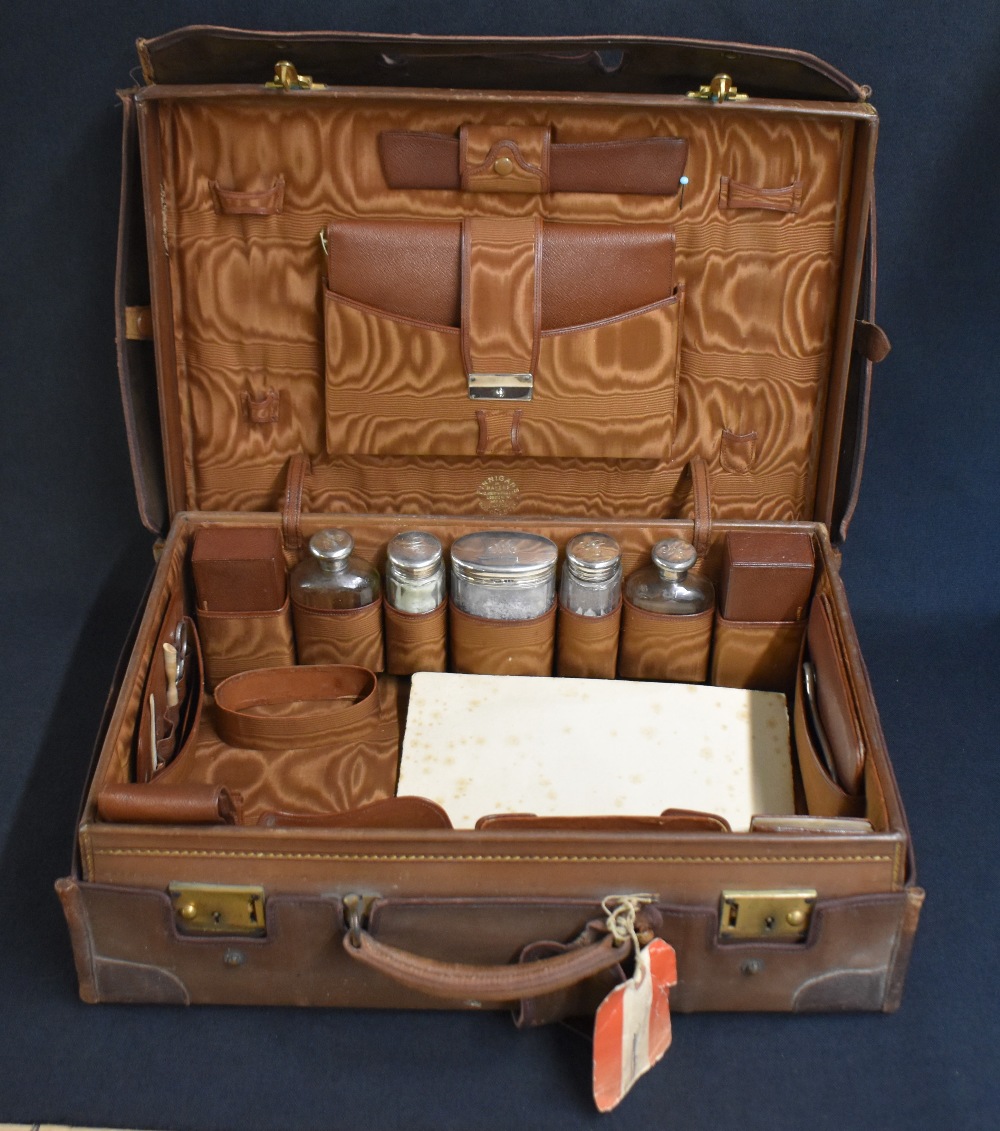 An early 20th century cased travelling set, the brown leather case with protective cover - Image 2 of 4