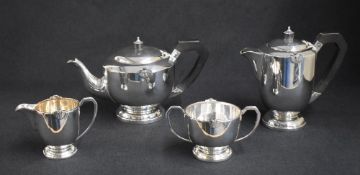 A George VI silver four piece tea set, comprising a teapot, coffee pot, sugar and cream, of circular