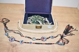 A cream faux leather jewellery box, containing a small collection of costume jewellery including