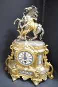 A late 19th century 8 day French fiqural mantel clock having porcelain dial with roman numeral,