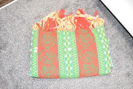 A large wool blanket decorated with green and red geometric patterns, w120cm