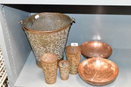 An Arab style copper bucket having repousse floral patterns, h25cm, sold together with a set of