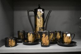 A Portmeirion Phoenix pattern tea service, decorated with gold colour peacocks on a black