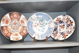 A Japanese porcelain charger decorated with tree in full blossom and blue and white geometrical