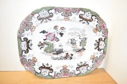 A large Chinese charger decorated with multicolour scrolling patterns and landscape scenes on an ice