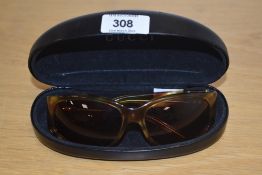 A pair of Gucci sunglasses with original case