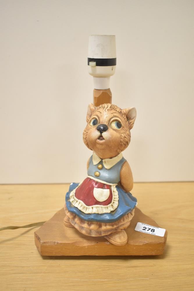 A vintage oak table lamp on triangular base with disney cat figure , h25cm