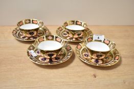 A set of four Royal Crown Derby Old Imari pattern cup and saucers in blue and red with gilt