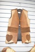 An Impala waistcoat in tan colour having heart pockets and tassel style trims.
